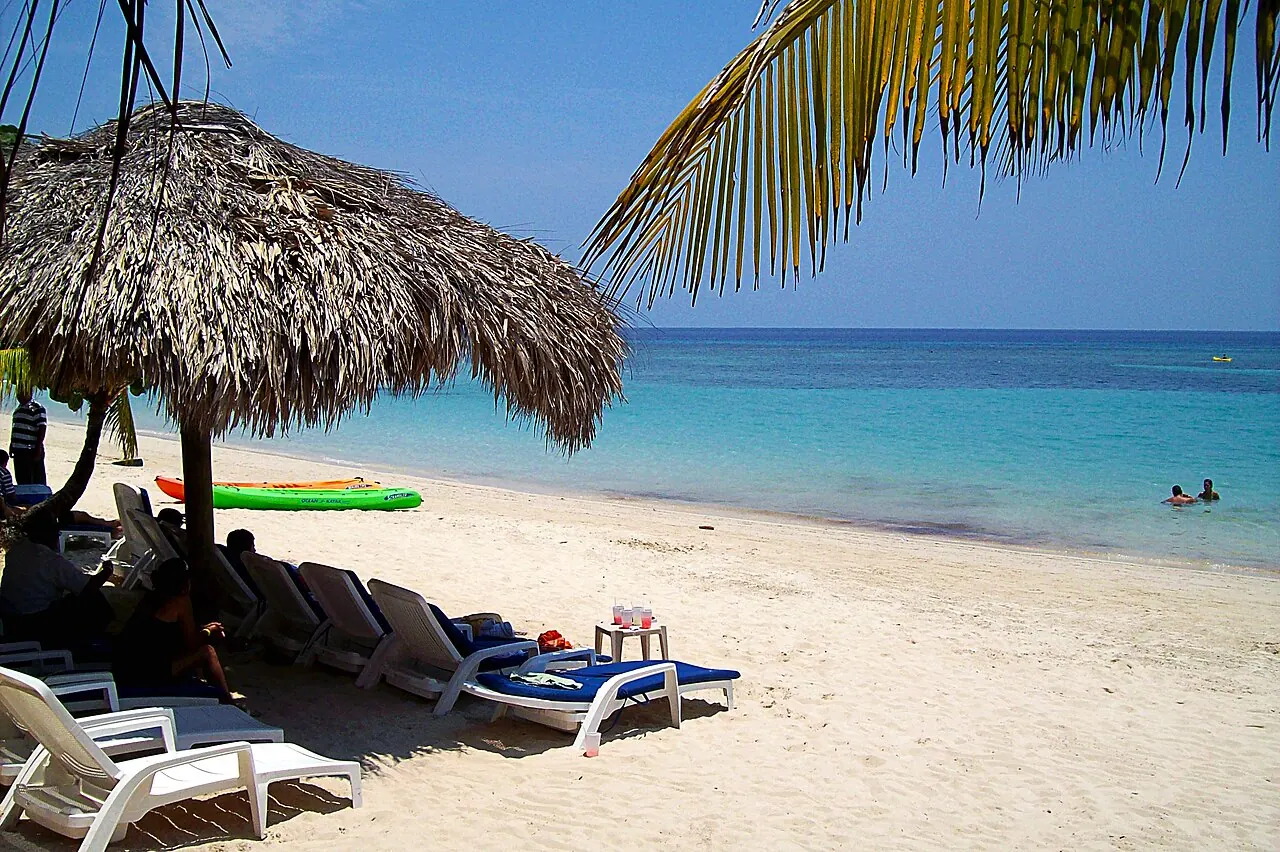 West Bay Beach on Roatan under a palm-thatched umbrella